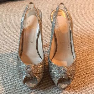 Gold, glittery, open-toe slingback Louboutins.